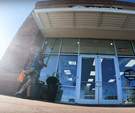 Heights Residential crew member washing windows on bosuns chair