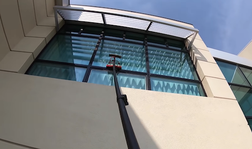 Heights Residential crew member washing windows on bosuns chair